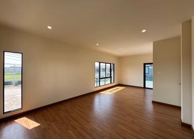 spacious living room with hardwood flooring and large windows