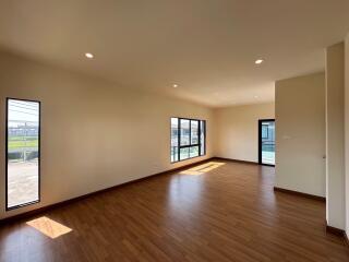 spacious living room with hardwood flooring and large windows