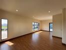 spacious living room with hardwood flooring and large windows