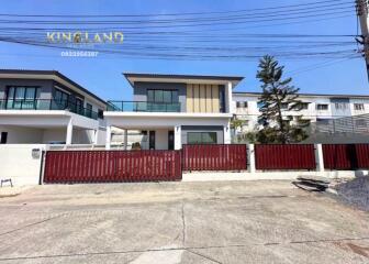 Modern two-story house with red gate