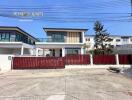 Modern two-story house with red gate