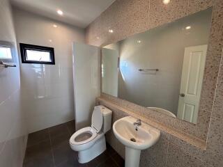 Modern bathroom with large mirror and sleek fixtures