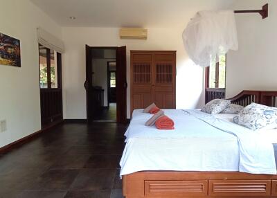 Bedroom with wooden bed and white bedding