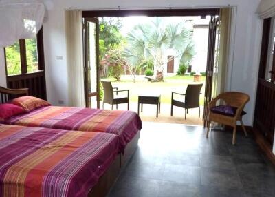 Bedroom with twin beds, view to garden