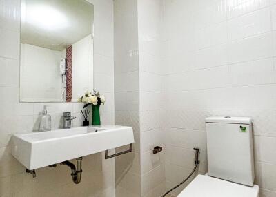 Modern bathroom with white tiles and fixtures