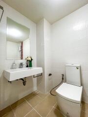 Modern bathroom with white tiles and fixtures