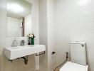 Modern bathroom with white tiles and fixtures