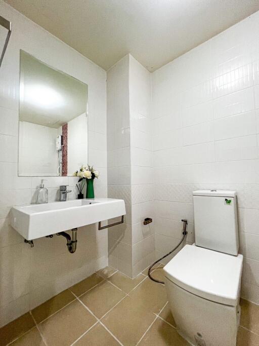 Modern bathroom with white tiles and fixtures