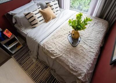 Cozy bedroom with bed, side table, and window view