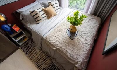 Cozy bedroom with bed, side table, and window view