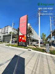 Condominium building exterior with advertisement and contact information