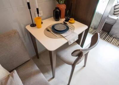 Small dining table with chairs set near a living space