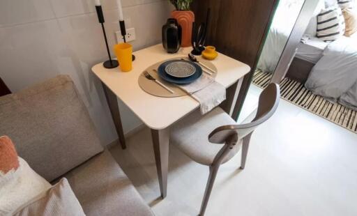 Small dining table with chairs set near a living space