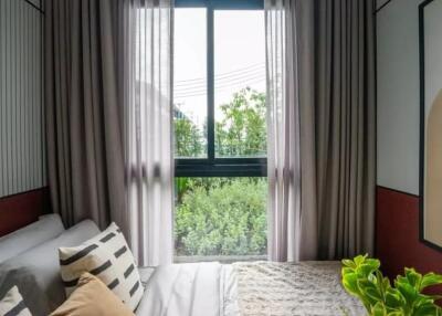 Cozy bedroom with large window and plants