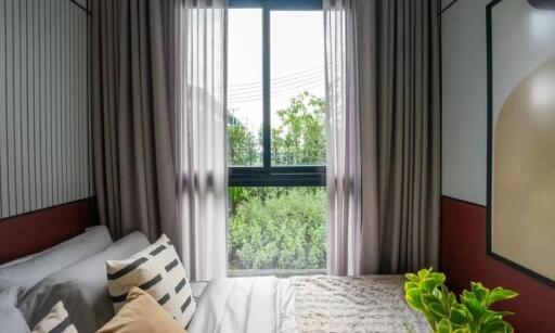 Cozy bedroom with large window and plants