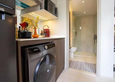 Modern laundry area next to a bathroom