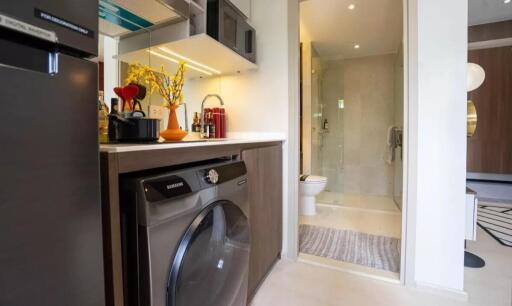 Modern laundry area next to a bathroom