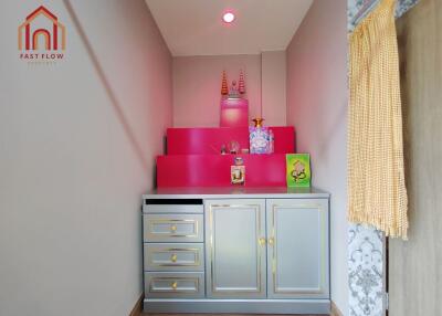 Decorative corner with vibrant red accents and storage cabinet