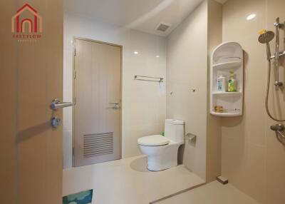 Modern bathroom with toilet, shower, and storage