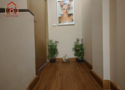 Hallway with wooden flooring and decorative plants