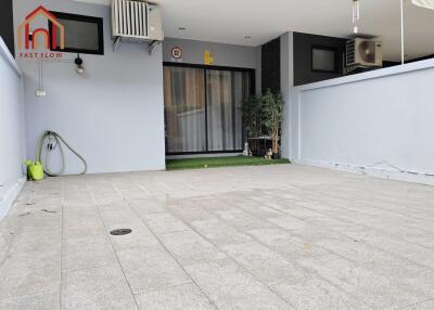 Covered patio area with tiled flooring and sliding patio doors