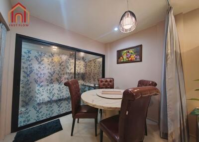 Dining area with round table and upholstered chairs