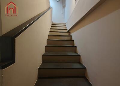 Modern staircase with black handrail