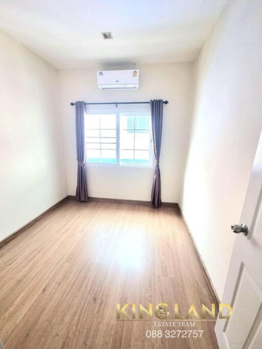 Empty bedroom with window and AC