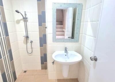 Modern bathroom with shower, sink, and toilet