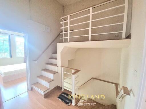 staircase leading to upper floor with modern railing