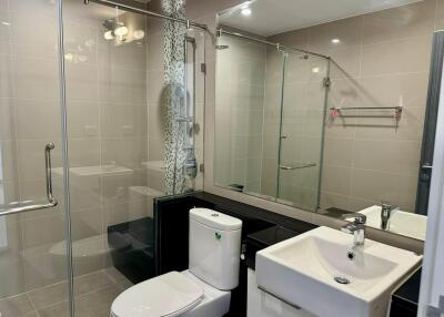 Modern bathroom with glass shower enclosure and contemporary fixtures