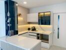 Modern kitchen with white cabinets and marble countertops