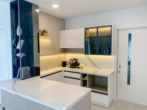 Modern kitchen with white cabinets and marble countertops