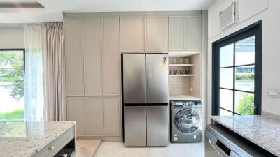 modern kitchen with large refrigerator and washing machine