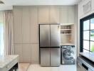 modern kitchen with large refrigerator and washing machine