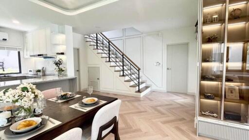 Modern living room with staircase and dining area