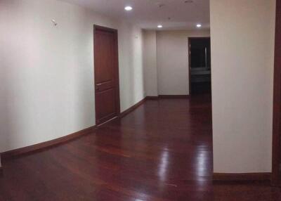 Spacious and well-lit hallway with wooden flooring