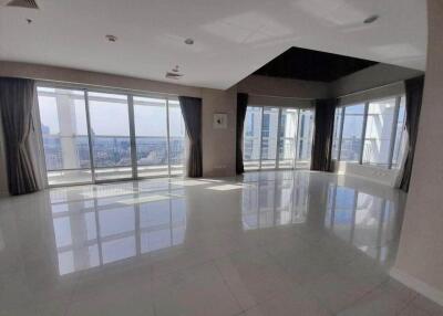 Spacious living area with large windows and city views