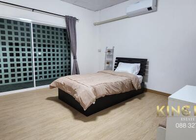 Modern bedroom with large window and air conditioning