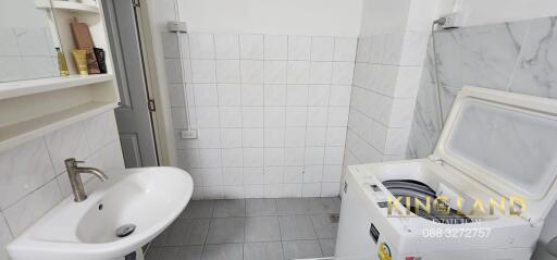 Laundry room with sink and washing machine