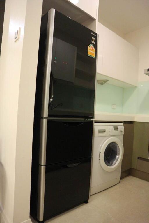 Modern kitchen with refrigerator and washing machine