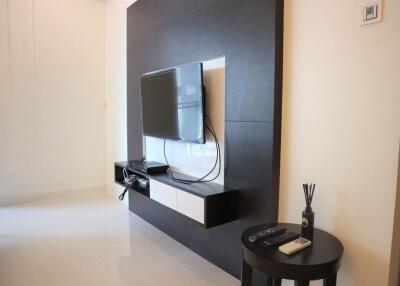 Modern living room with mounted TV and small side table