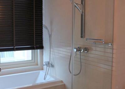 Modern bathroom with a bathtub and a glass-enclosed shower