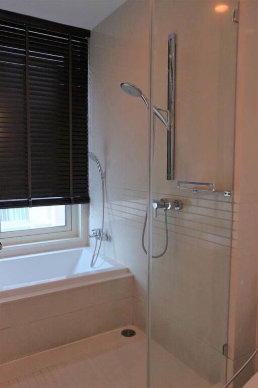 Modern bathroom with a bathtub and a glass-enclosed shower