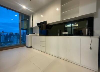 Modern kitchen with white cabinets and large window