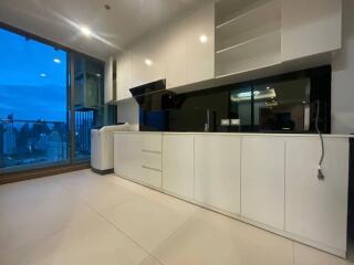 Modern kitchen with white cabinets and large window