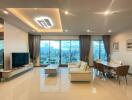 Modern living room with dining area and city view