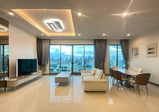 Modern living room with dining area and city view