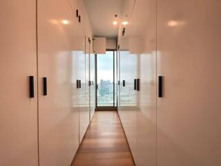 Hallway with storage closets and large windows