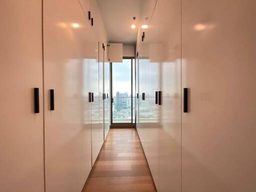 Hallway with storage closets and large windows